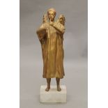 A gilt-painted sculpture of an angel mounted on a composite stone plinth base. 105 cm high.