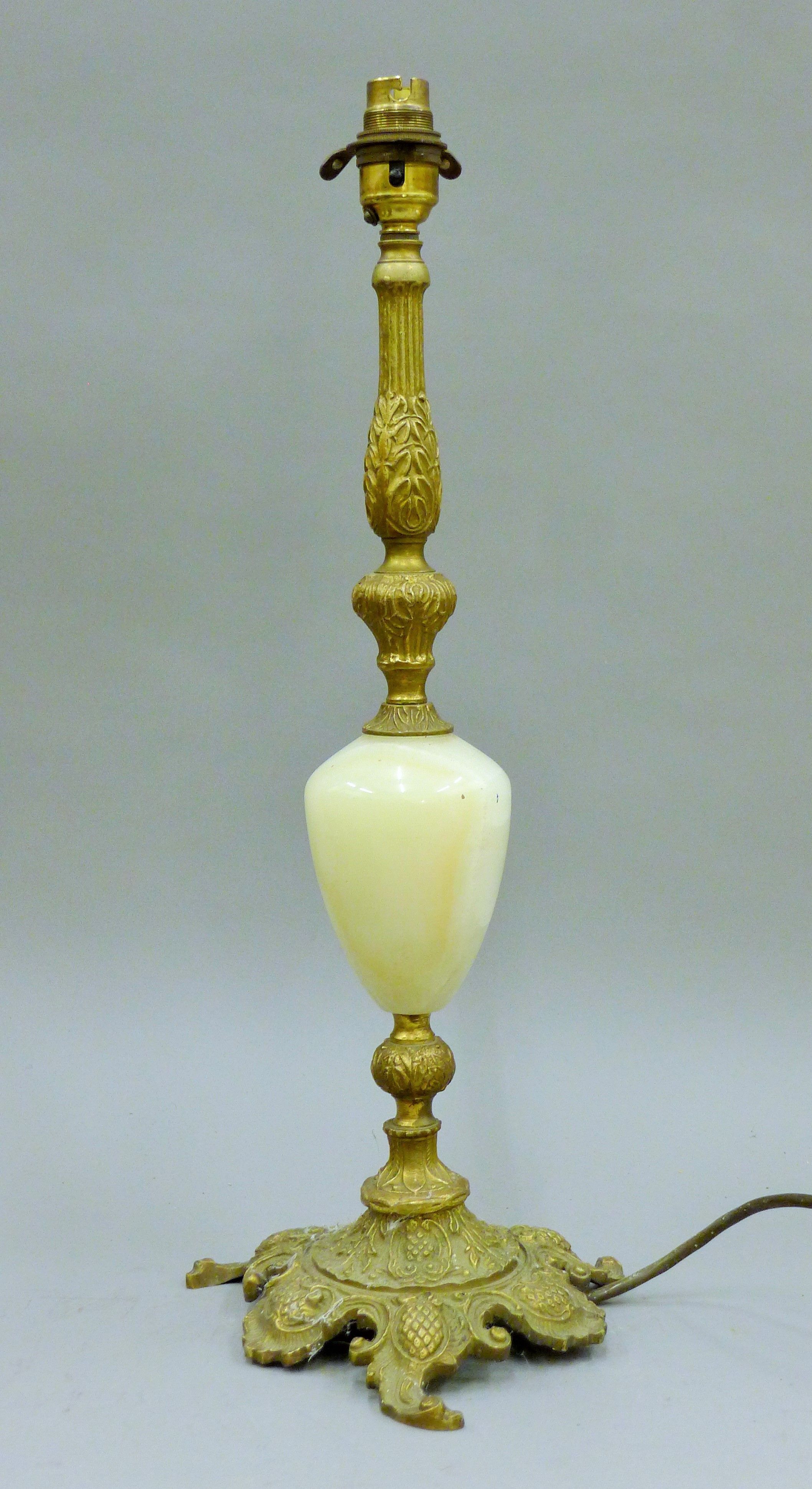 A gilt metal and onyx table lamp. 48 cm high.