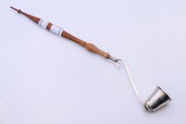 A Tiffany silver mounted candle snuffer. 32 cm long.