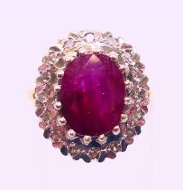 An 18 ct gold, ruby and diamond cluster ring. Ring size O.