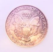 A 2003 one ounce fine silver USA one dollar coin.