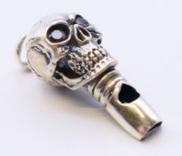 A silver whistle in the form of a skull. 3.5 cm high.
