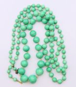A jade bead necklace. 104 cm long.