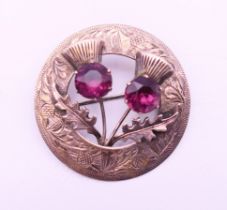 A Scottish silver hand engraved thistle brooch, hallmarked for Glasgow. 4.5 cm diameter.