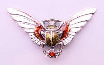 A silver brooch in the form of a winged beetle. 5.5 cm x 3 cm.