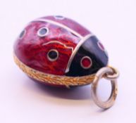 A silver and enamel pendant in the form of a ladybird. 2 cm high.