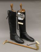 A pair of leather riding boots with boot trees,
