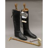 A pair of leather riding boots with boot trees,