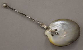 A 19th century 830 silver-handled oyster shell spoon. 20 cm long.