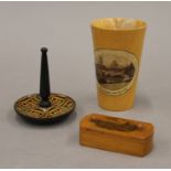 A Mauchline puzzle vesta, an Ely Cathedral beaker and a pin tray. The former 7 cm long.