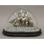 A 19th century Chinese silver model of the tea clipper Spindrift under a glass dome.