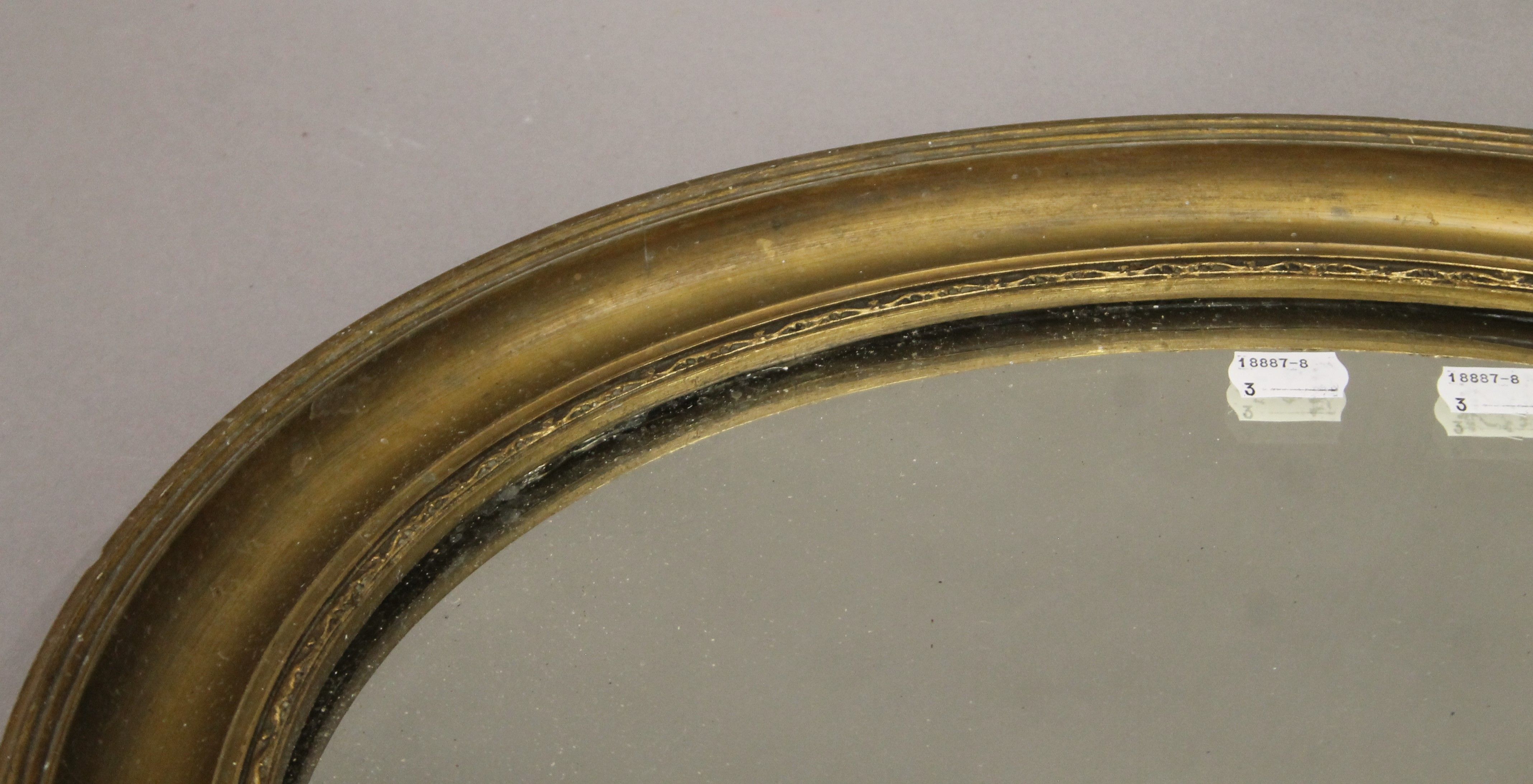 An early 20th century gilt-framed oval mirror. 58 cm wide. - Image 2 of 2