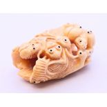 A bone carving in the form of bugs. 5 cm high.