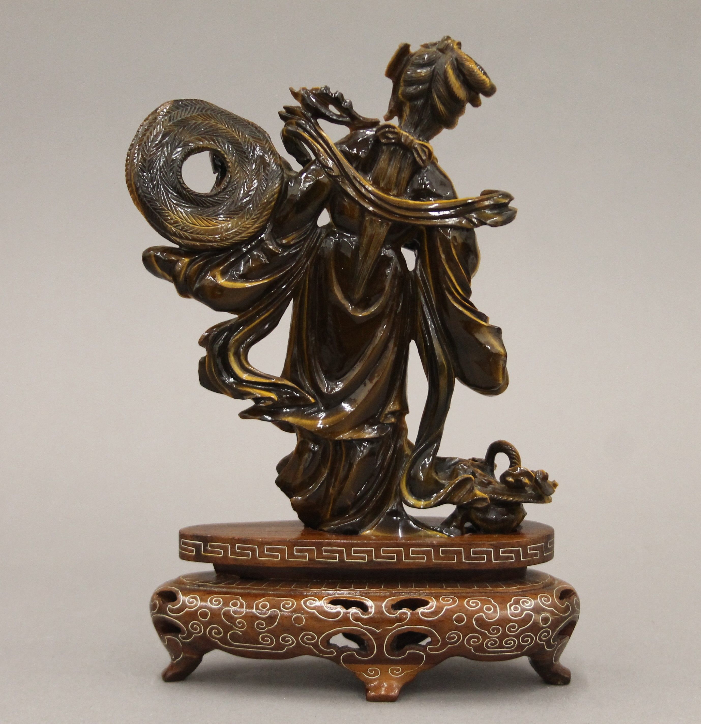 A Chinese tiger's eye hardstone carving of a maiden on a carved wood base. 18.5 cm high. - Image 4 of 5