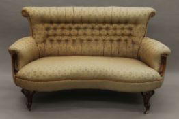 A Victorian button-upholstered mahogany settee. 145 cm long.