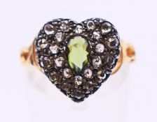 A gold diamond and green stone heart ring. Ring size N.