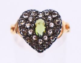 A gold diamond and green stone heart ring. Ring size N.