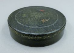A circa 1930's Hardy Bakelite fly box. 9.5 cm diameter.