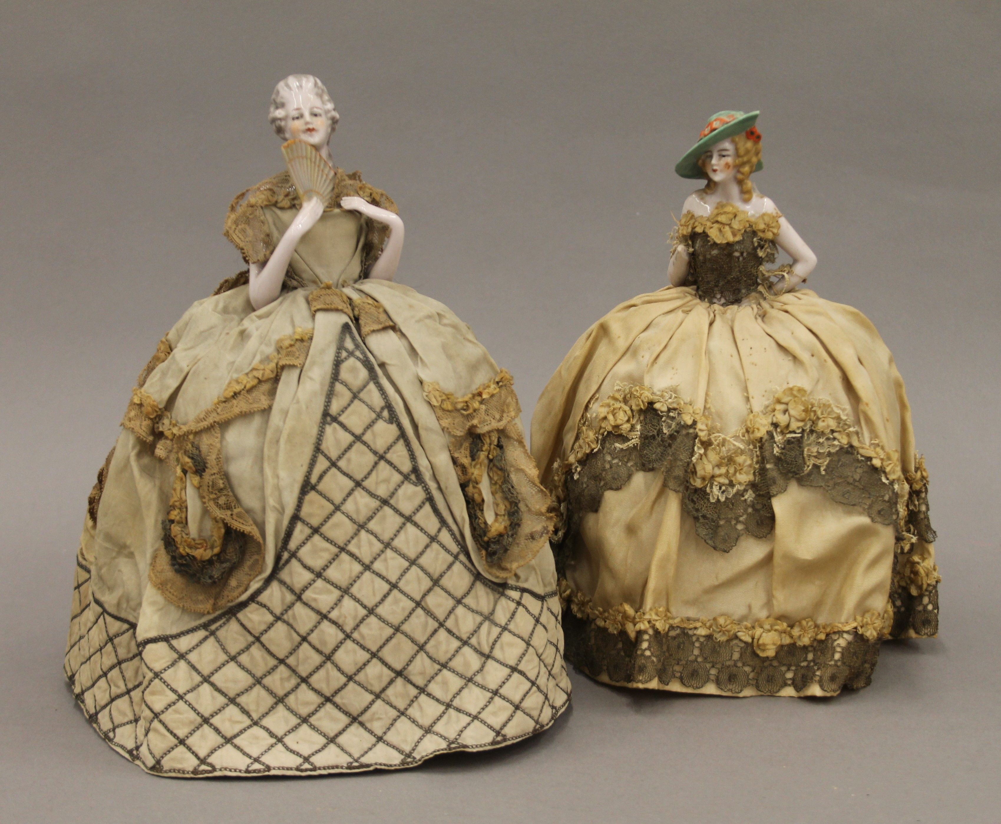 Two late 19th/early 20th century porcelain and lace half dolls. The largest 24 cm high.