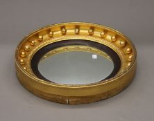 A Victorian gilt framed convex wall glass/mirror. 45 cm diameter.