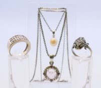 A collection of silver jewellery to include two silver pendant necklaces and silver rings. 24.