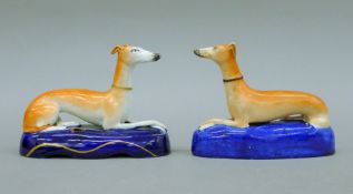 Two 19th century Staffordshire recumbent greyhound inkwells. The largest 15 cm long.