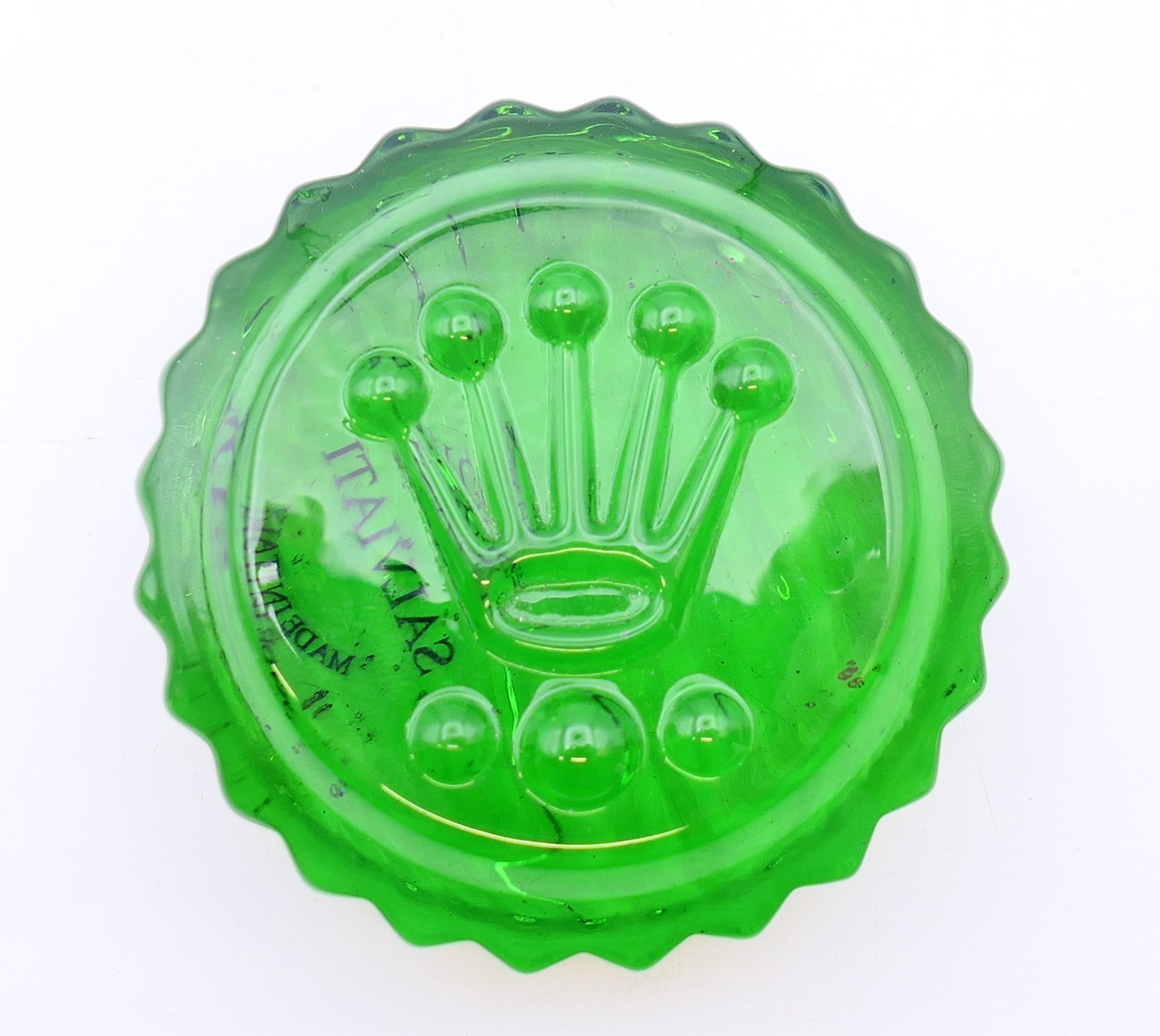 A round Rolex green glass paperweight. 7 cm diameter.