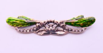 A silver brooch in the form of two dragon flies. 7 cm long.