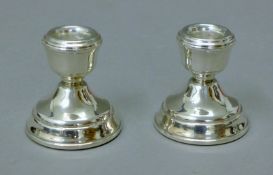 A pair of silver dwarf candlesticks. 6 cm high.