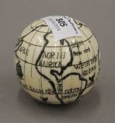 A bone globe compass. 7 cm high.