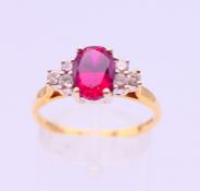 An 18 ct gold, diamond and ruby ring. Ring size S.