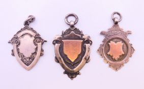 Two rose gold and silver Albert chain fobs and a silver Albert chain fob,