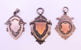 Two rose gold and silver Albert chain fobs and a silver Albert chain fob,