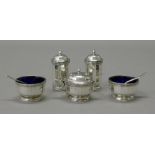 A silver five-piece cruet set. The peppers 6.5 cm high. 162.1 grammes.