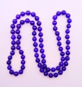 A string of lavender jade beads. 72 cm long.