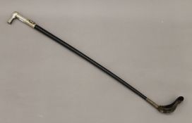 A riding crop with a silver plated handle decorated with sporting motifs. 80 cm long.