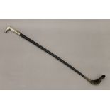 A riding crop with a silver plated handle decorated with sporting motifs. 80 cm long.