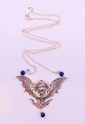 A silver Art Nouveau style winged female head pendant on a silver chain.