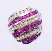 A silver ruby and cubic zirconia five-row ring. Ring size R/S.