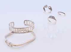 Two silver bracelets and three silver rings. 39.7 grammes total weight.