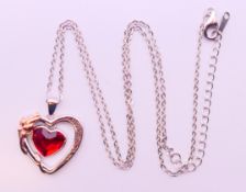 A silver heart pendant inscribed 'Always in my heart' on a silver chain, boxed.