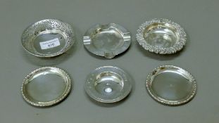 A quantity of small silver dishes and an ashtray. The largest 10.5 cm diameter. 313.4 grammes.