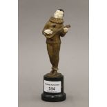 An Art Deco patinated bronze and ivory figure of a musician mounted on a marble plinth base.