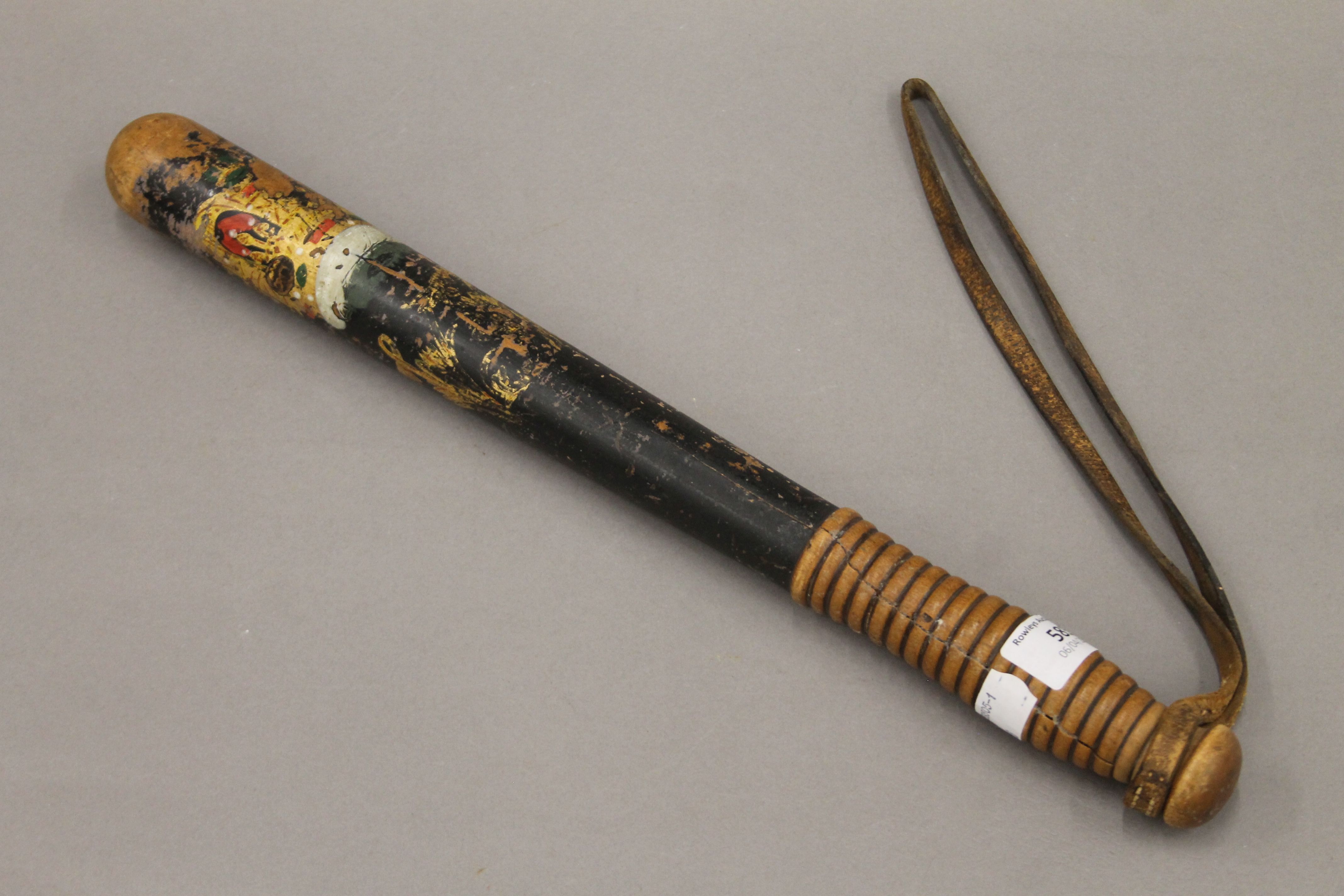 A Victorian painted wooden truncheon. 43 cm long.