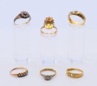 Three 18 ct gold rings 6.9 grammes total weight, a 9 ct gold ring and two unmarked rings.7.