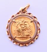 A 1963 gold sovereign set as a pendant in a 9 ct gold mount. 3 cm diameter. 11.