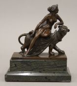 A 19th century bronze sculpture depicting a nude female astride a lioness mounted on a marble
