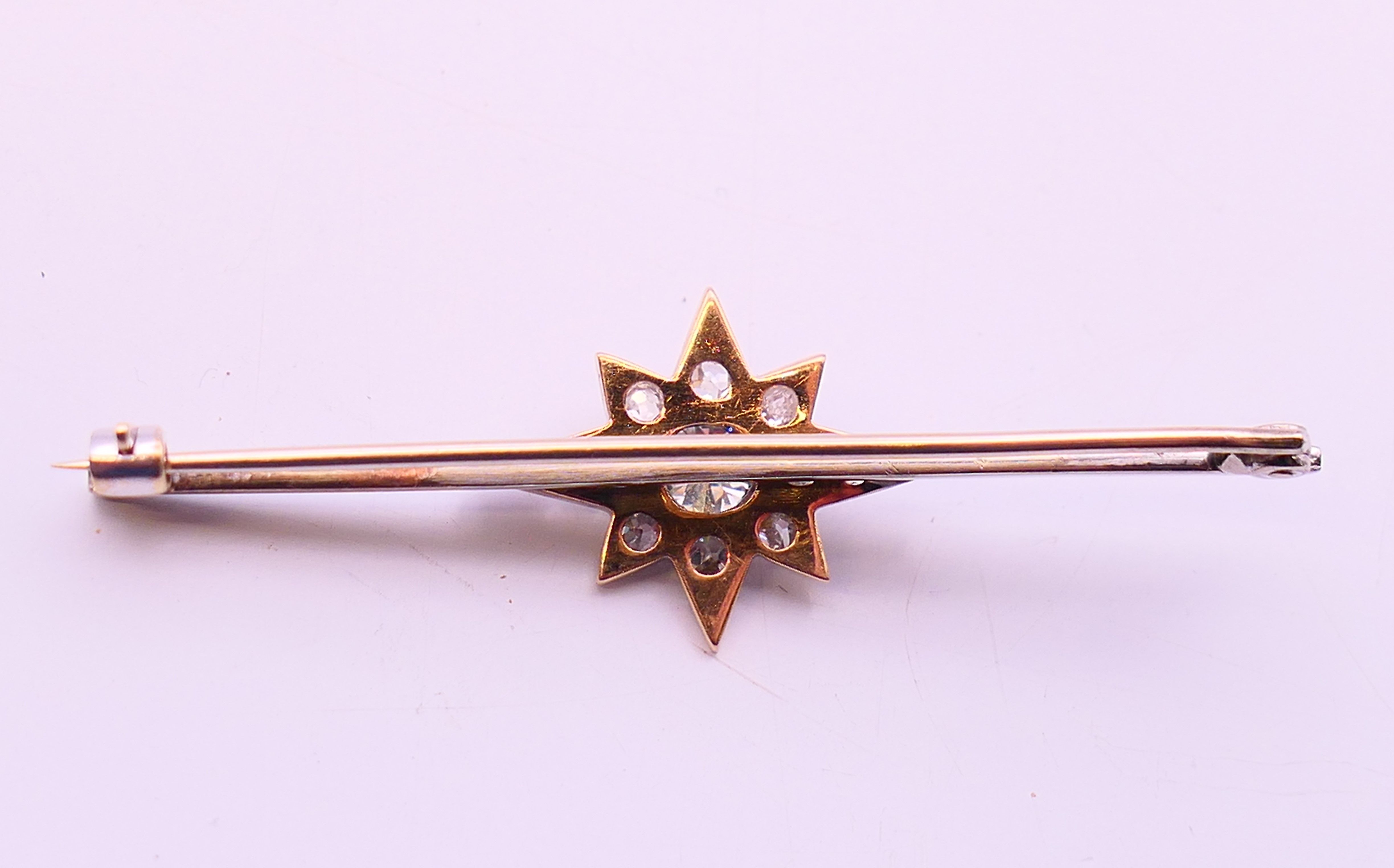 An antique bar brooch with diamond set star design, the central diamond approximately 0.5 carat. - Image 4 of 7