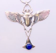 A silver and lapiz scarab pendant on silver chain. Pendant 9 cm high, chain 45 cm long.
