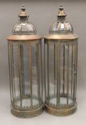 A pair of large copper-coloured lanterns. 90 cm high.